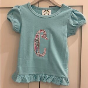 Blue Ruffle Shirt with Floral ‘C’ Appliqué NWOT